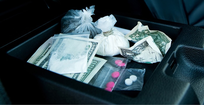 Drugs and cash in a center console of a car